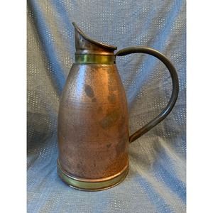H Copper and brass pitcher